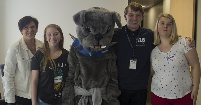 Pilar Lopez poses with OLS students and Bellevue College's mascot, Brutus.