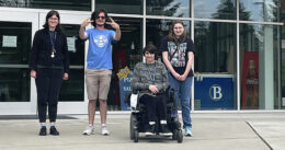 OLS students pose in front of BC housing.