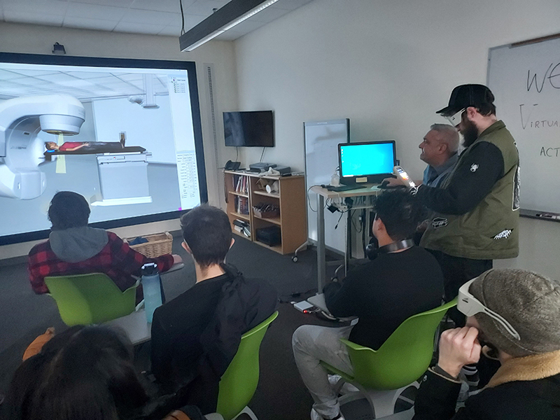 OLS students view specialized imagery on the Health Sciences, Education and Wellness Institute tour.