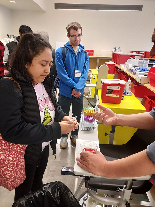 OLS students learn about collecting fluid samples on the Health Sciences, Education and Wellness Institute tour.