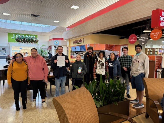 OLS students pose with job applications at the mall.