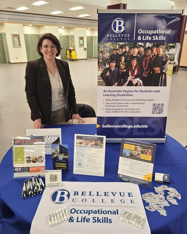 Pilar Lopez poses with OLS materials at a tabling event.