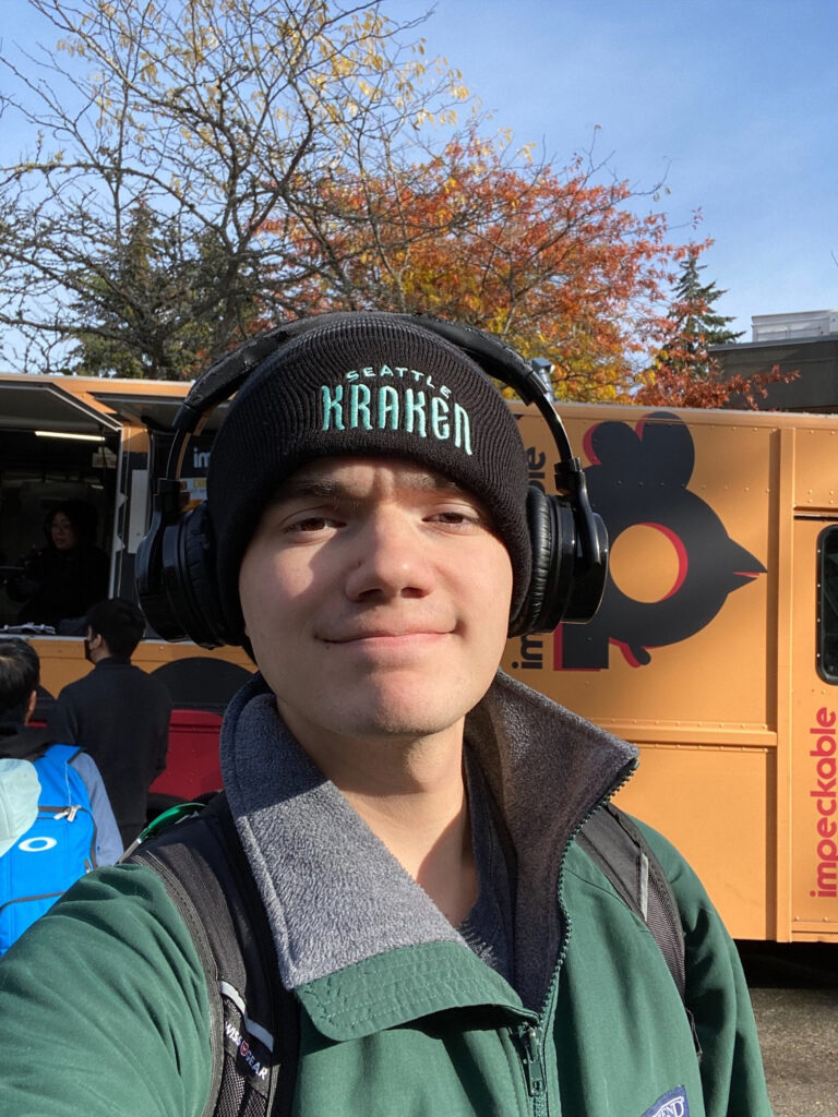 Zeke poses in front of a food truck on the Bellevue College campus.