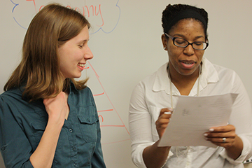 A student and an instructor review a document together.