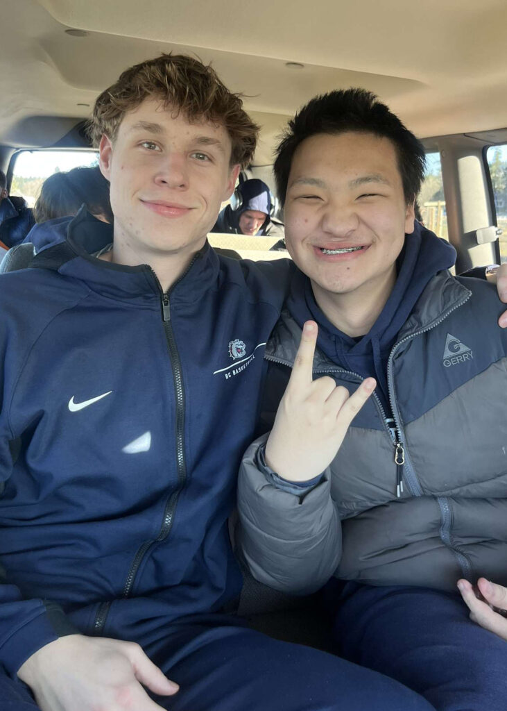 Logan Kassebaum and BC basketball player pose for a photo together on a road trip. 