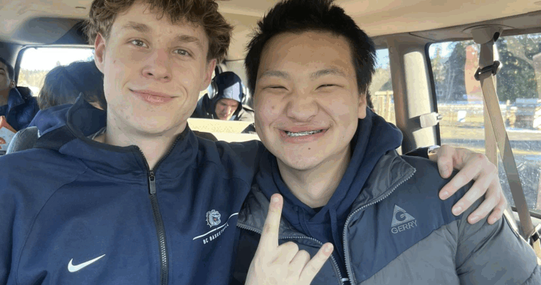 Two Bellevue College students smiling in a van