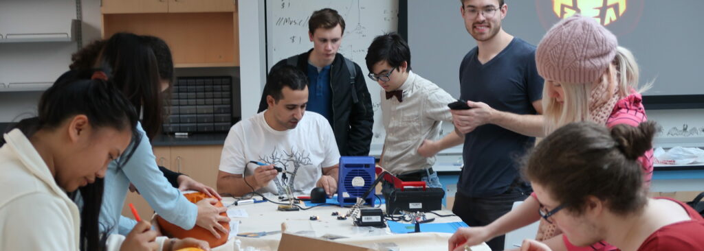 Students gathered around a Maker space and creating STEM related projects