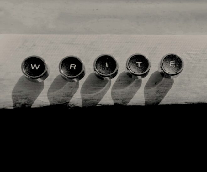 metal typewriter keys spelling "write" on a wooden surface