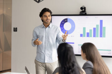 An instructor speaking in front of the class.