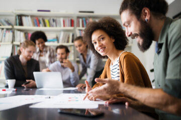 Group of people working on a project on a table.