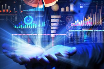 Hands cupping glowing light beneath floating financial charts and graphs.