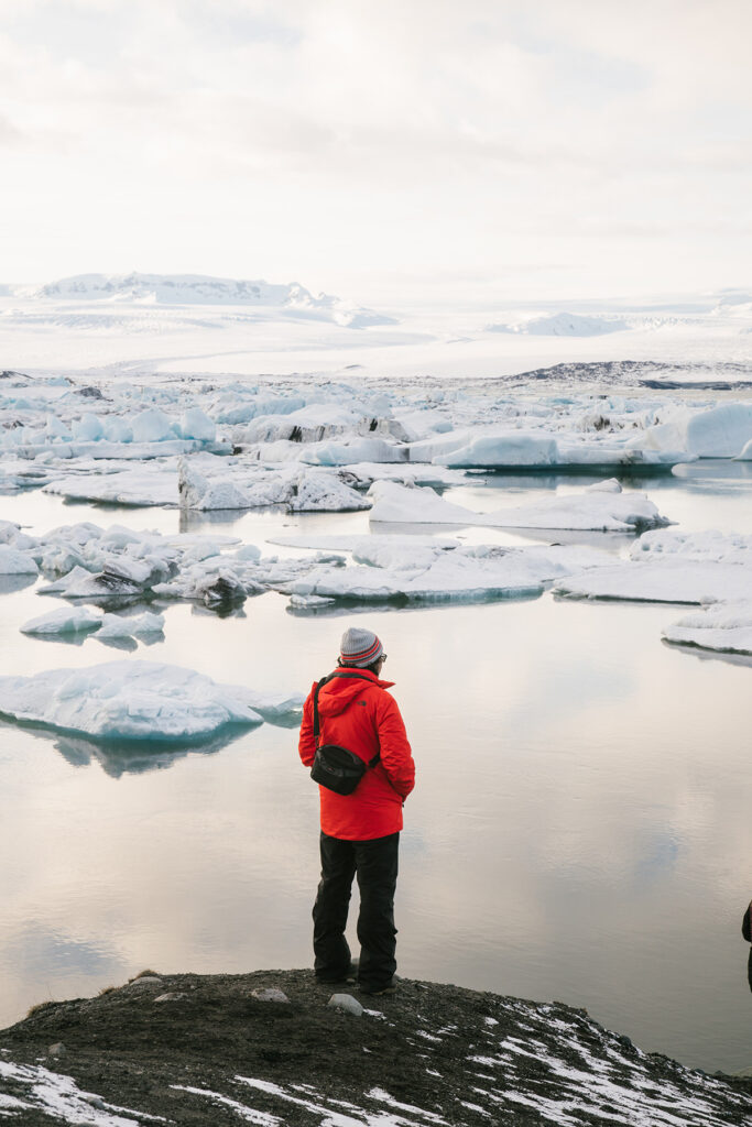 A hiker surveys ice floes on the horizon.