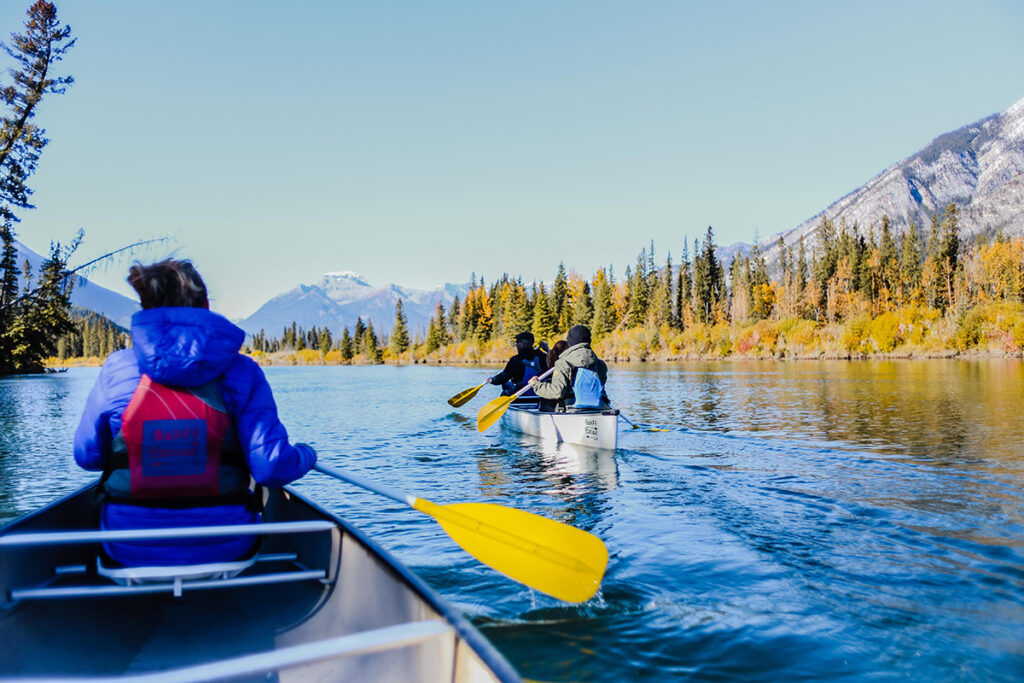 Canoers paddle in a mountain stream.