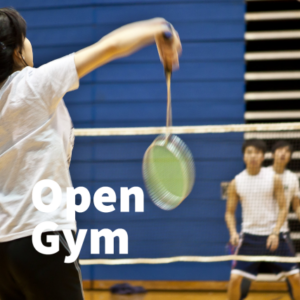 Students playing badminton in the gym.