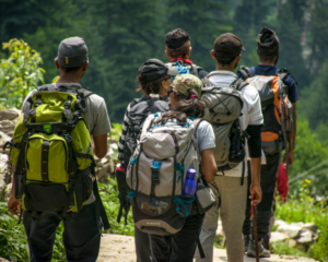 Group of hikers with backpacks heading up an open trail