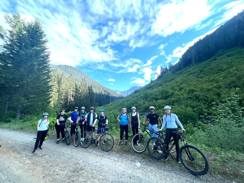 Stopping to pose with bikes along the Palouse to Cascade Trail under a blue sky with amazing clouds.