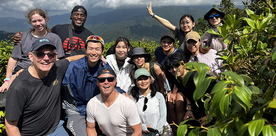 An outdoor adventure for sure: students and faculty travel to Costa Rica to explore the green lifestyle, pictured here in a group photo in front of mist covered mountains.
