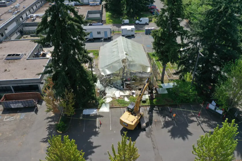 Aerial shot of greenhouse with crane. 