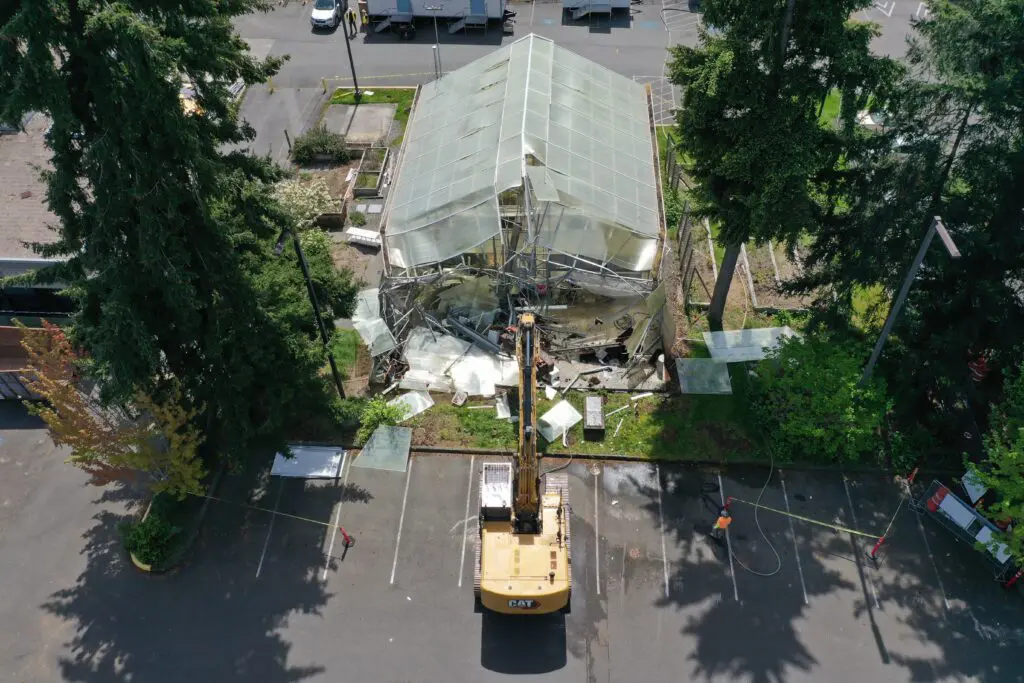 Aerial shot of greenhouse with crane. 