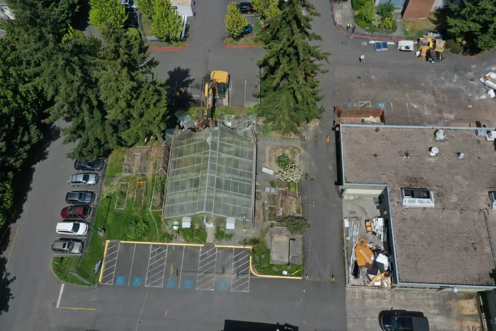 Aerial shot of greenhouse with crane. 