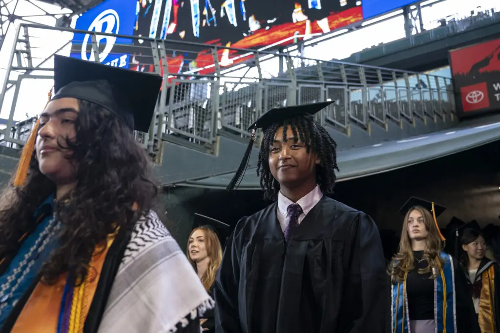 BC graduates proceed to receive their diplomas.