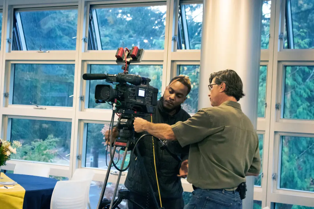 A student sets up a camera to film a BC event.