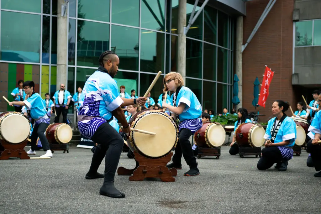 Students drum on campus.
