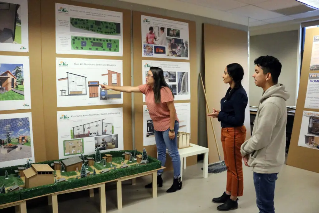 Interior design students display presentations.