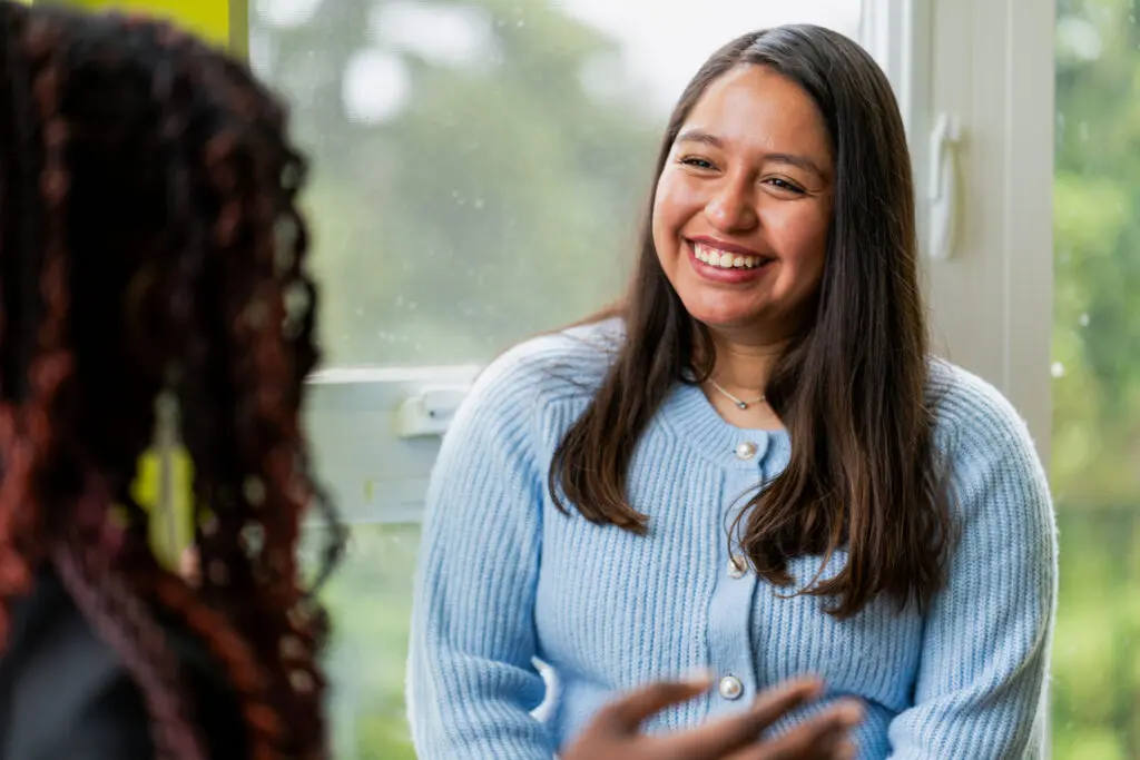 A student smiles while in conversation.
