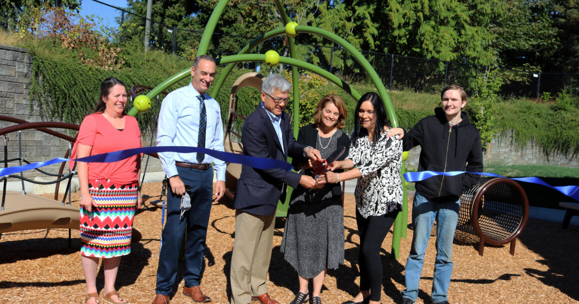 Gary Locke and Sheri Flies cut a ribbon to celebrate the ELC playground renovation on September 6.