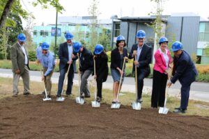 BC staff and community members digging into dirt with shovels