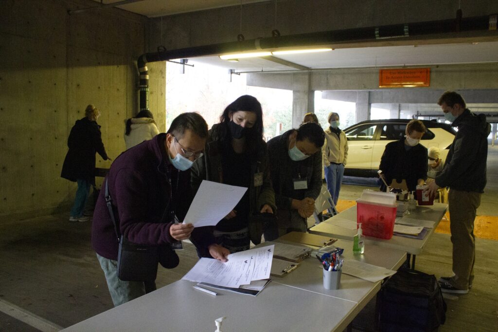 Volunteers gather in the parking garage