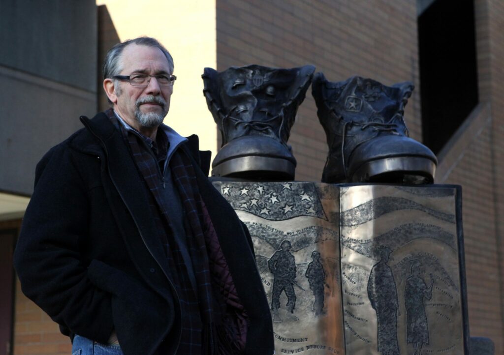 Sculptor and former BC art instructor Ross Brown stands in front of his work