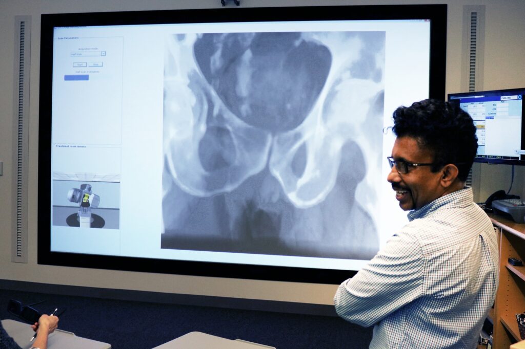 Faculty member standing in front of VERT screen