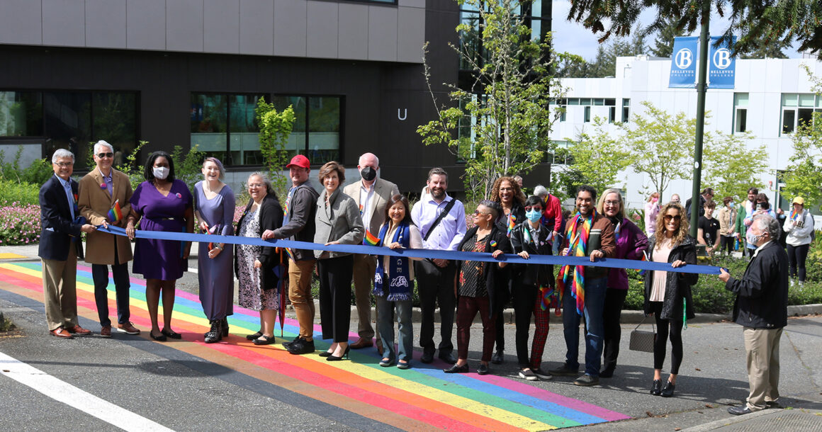 Cutting the ribbon at the rainbow crosswalk dedication