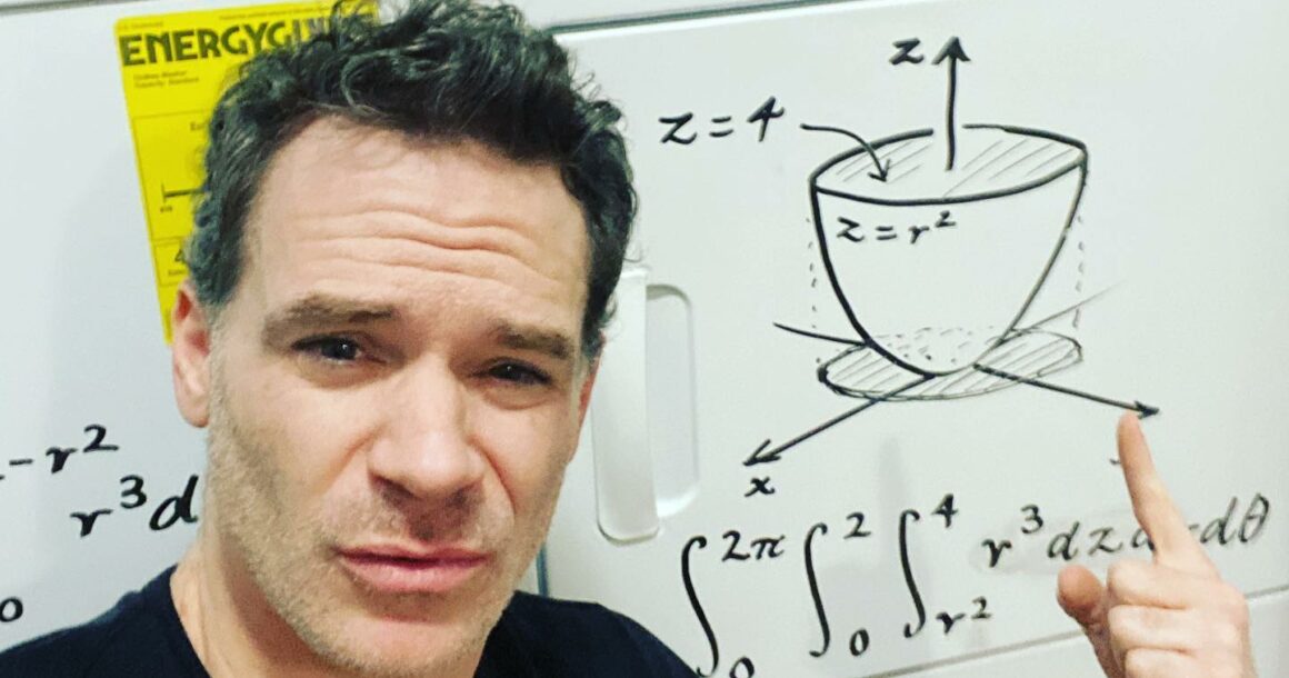 Math instructor Luke Rawlings uses his washer and dryer as a whiteboard to write out equations for students.