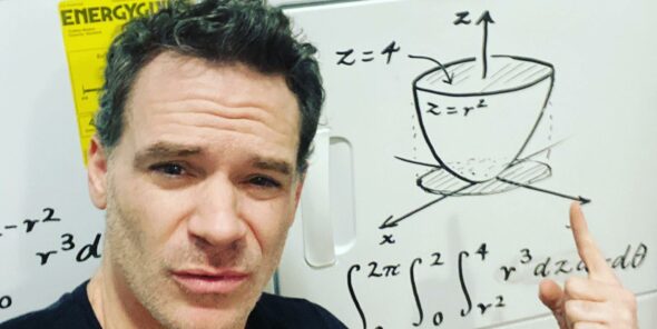 Math instructor Luke Rawlings uses his washer and dryer as a whiteboard to write out equations for students.