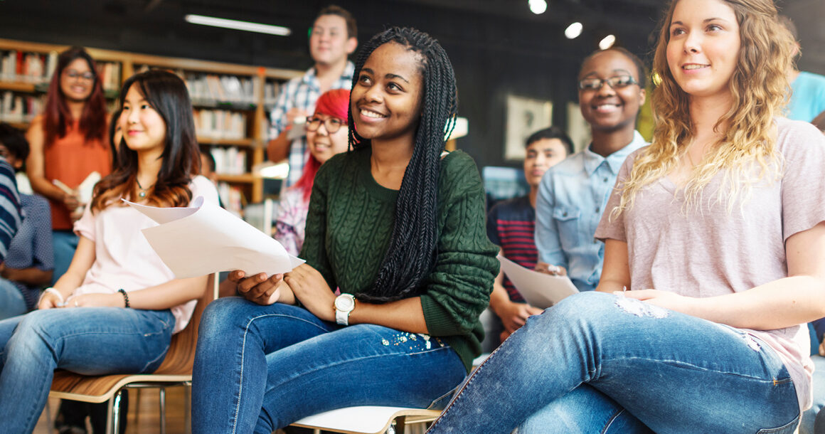 Students listen to a presentation in the library.