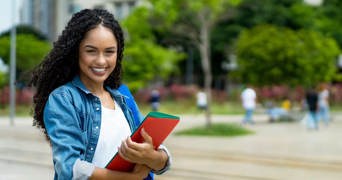 Student holding papers