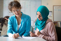 Two people work together on a document.