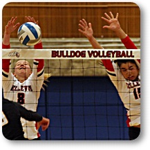 BC volleyball players go up for a block at the net