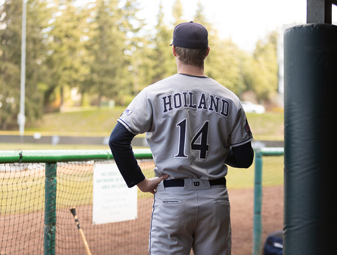 Baseball player Hoiland #14 surveys the baseball diamond.