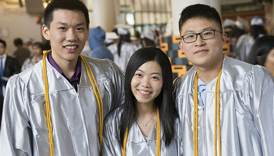 A group of graduates in white gowns