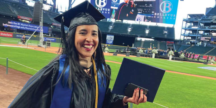 A student celebrating graduation on T-Mobile Field