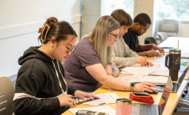 Students working at a long desk