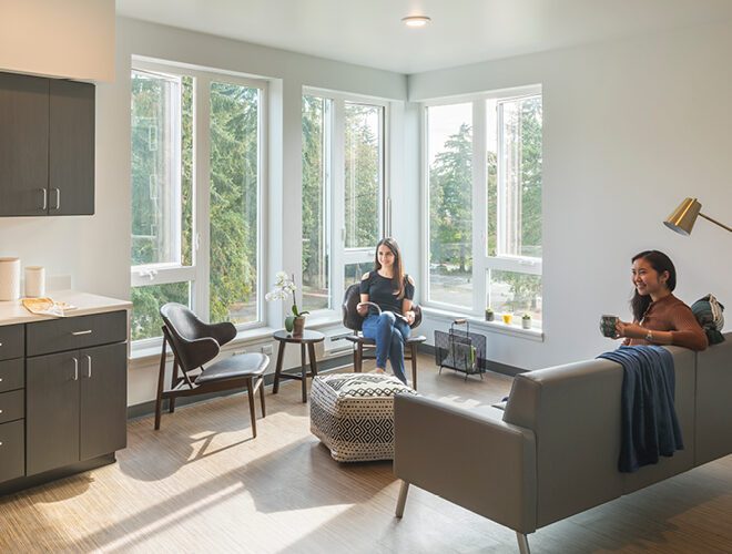 Two students lounge in BC student housing.