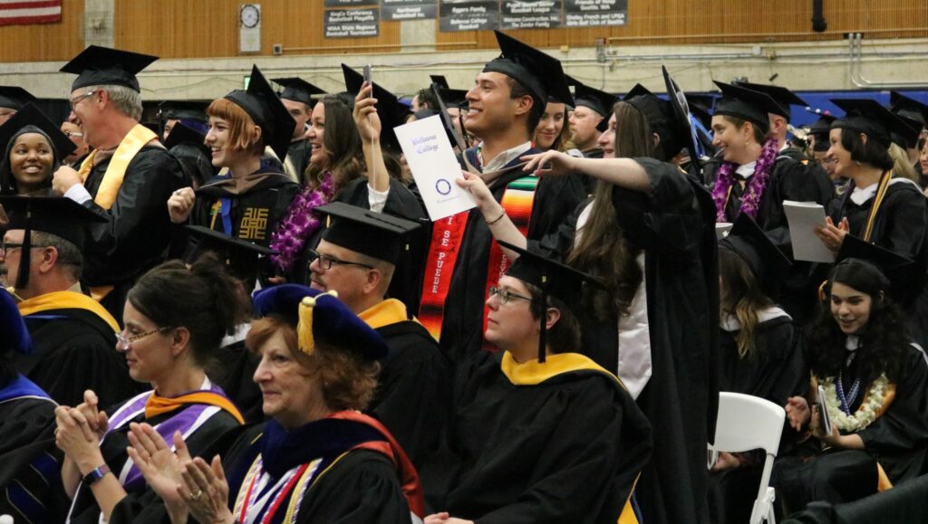 students cheer for friend during graduation ceremony