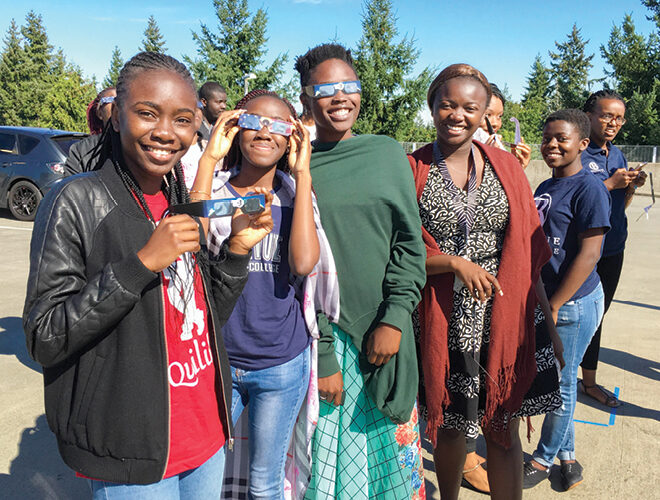 A group of students gather and don protective goggles.