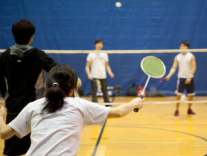 Teams play doubles badminton at BC's Fitness Center.