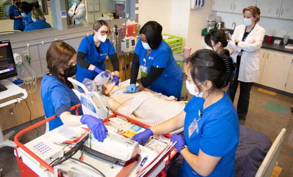 Students working on a dummy during a health class